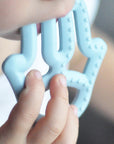 OiOi Baby Silicone Teether - Mineral Blue, Safe & Effective Teething Relief for Infants OiOi Baby Silicone Teether - Safe Teething Relief baby teether, silicone teether, teething relief for infants, non-toxic baby products, baby oral care, safe teething toys, OiOi, baby products, teething solutions, infant care, baby safety, durable teether, easy to clean teether, fine motor skills development