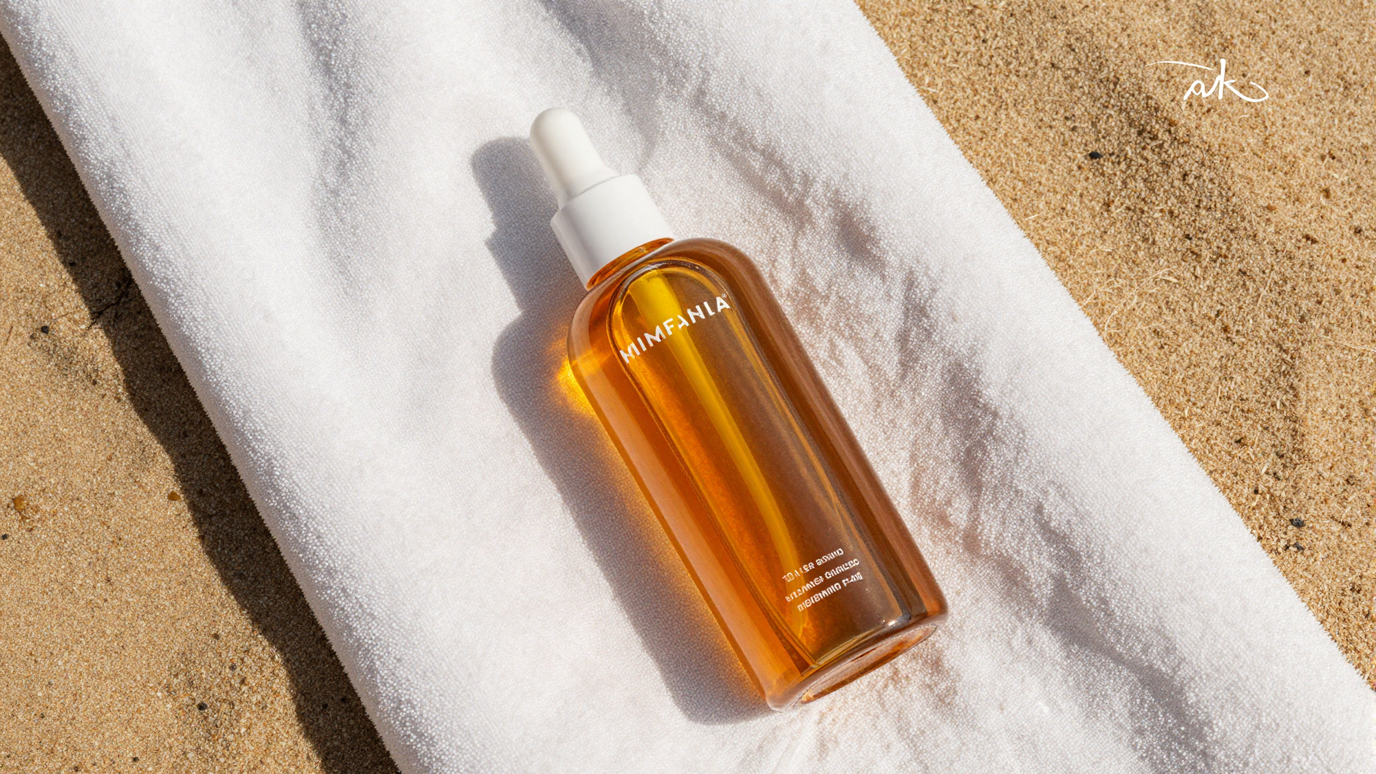 Carroten tanning oil bottle on a beach towel at sunset