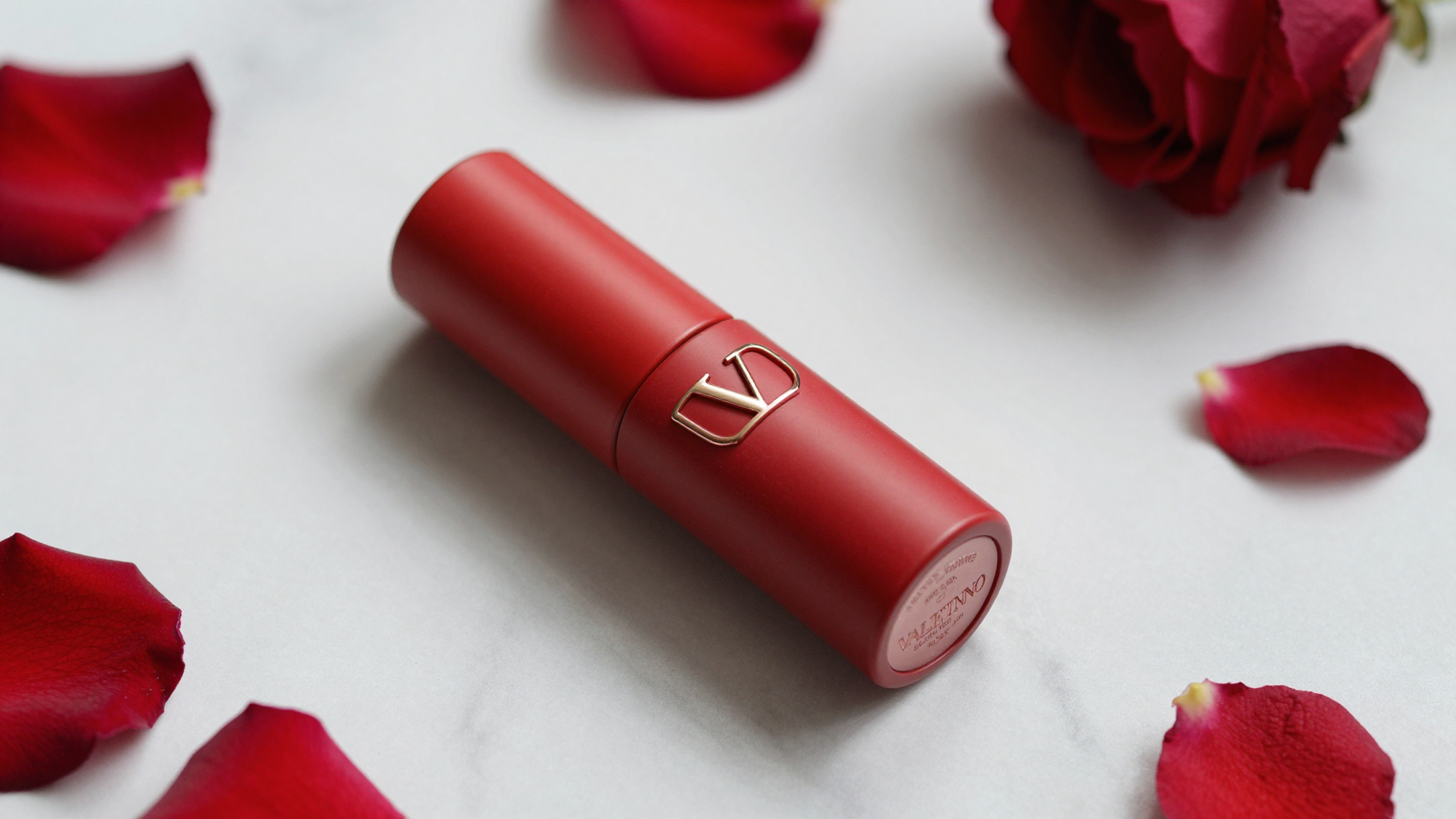 Valentino lipstick on marble with rose petals