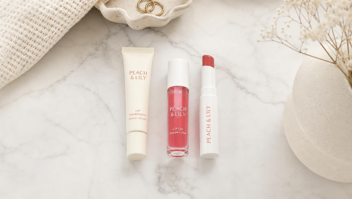 Flat lay of lip care products on a marble surface