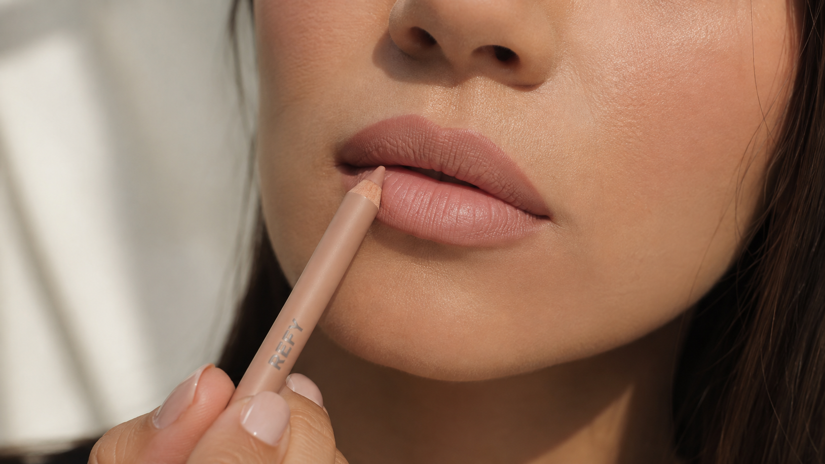 Hand applying lip liner
