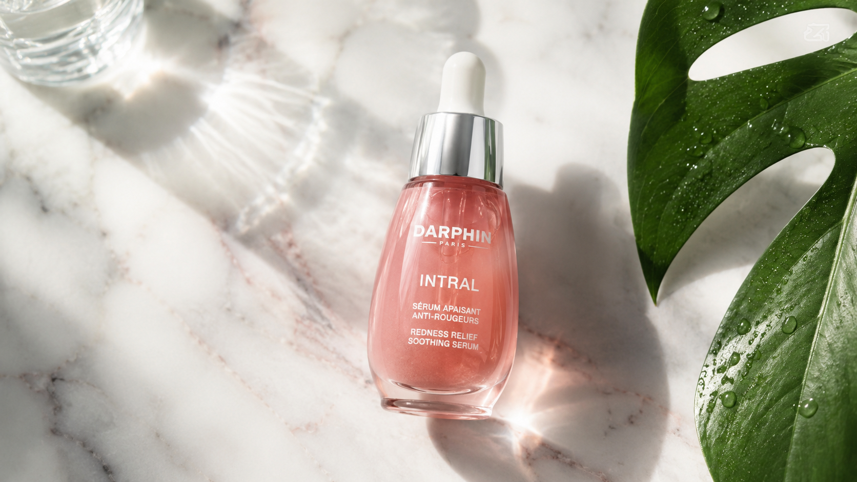 Darphin Intral serum bottle in bright natural light on marble