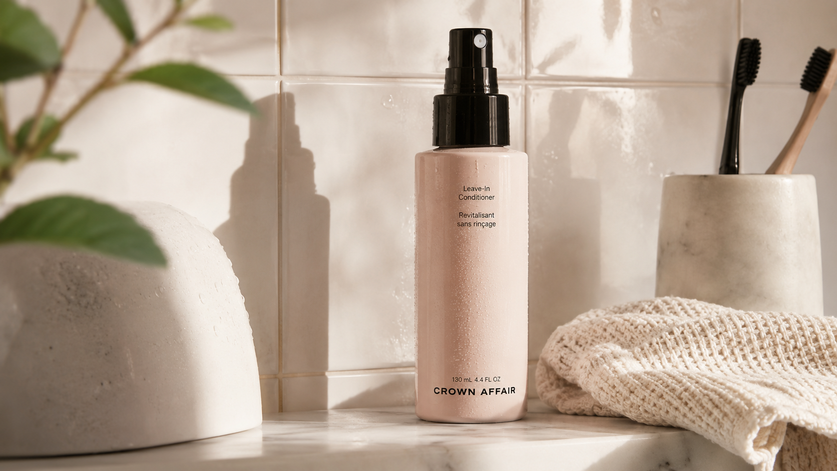 Crown Affair Leave-In Conditioner bottle on a bathroom shelf