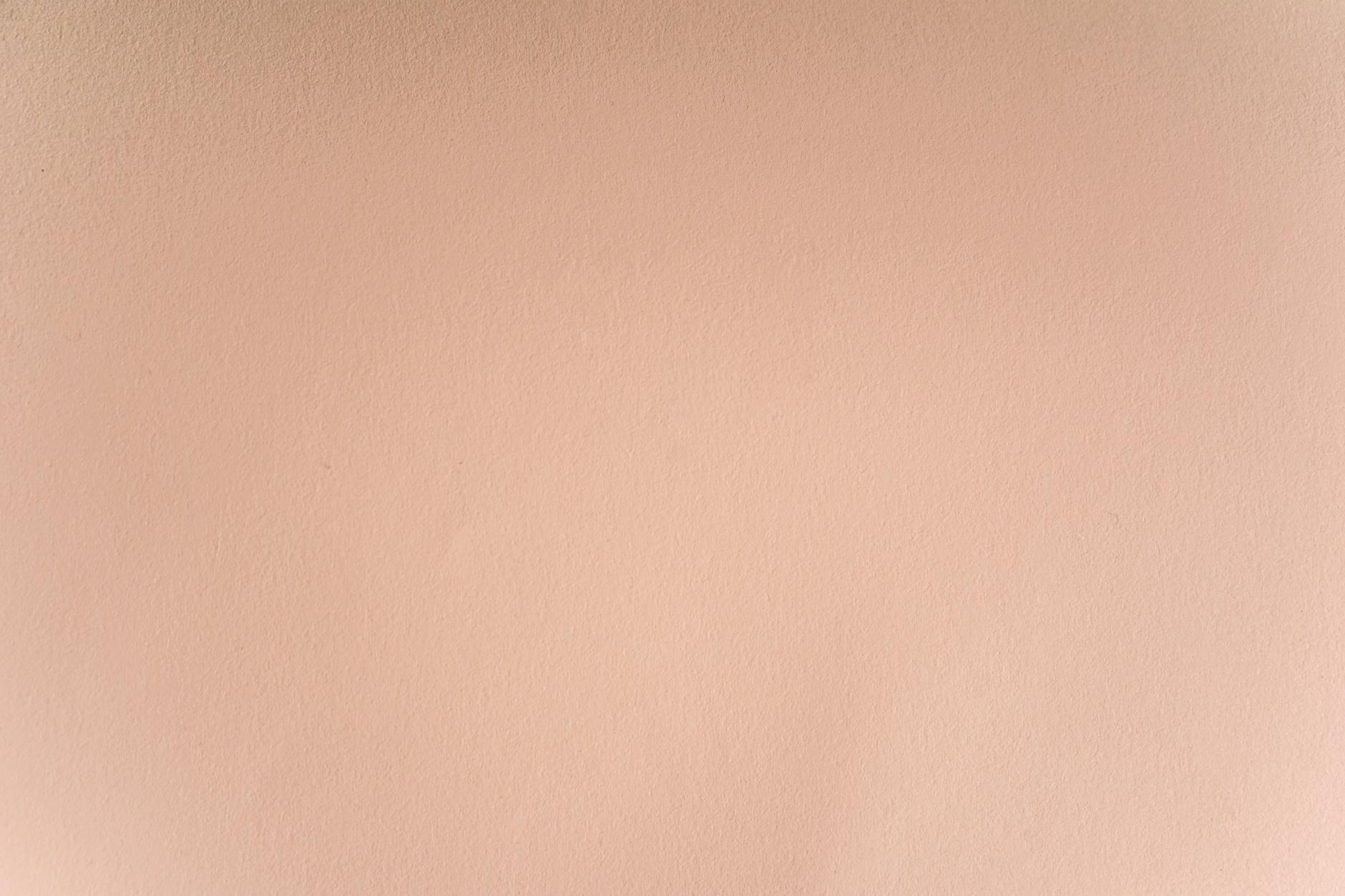 A seamless and smooth pastel pink wall texture perfect for backgrounds and design projects.