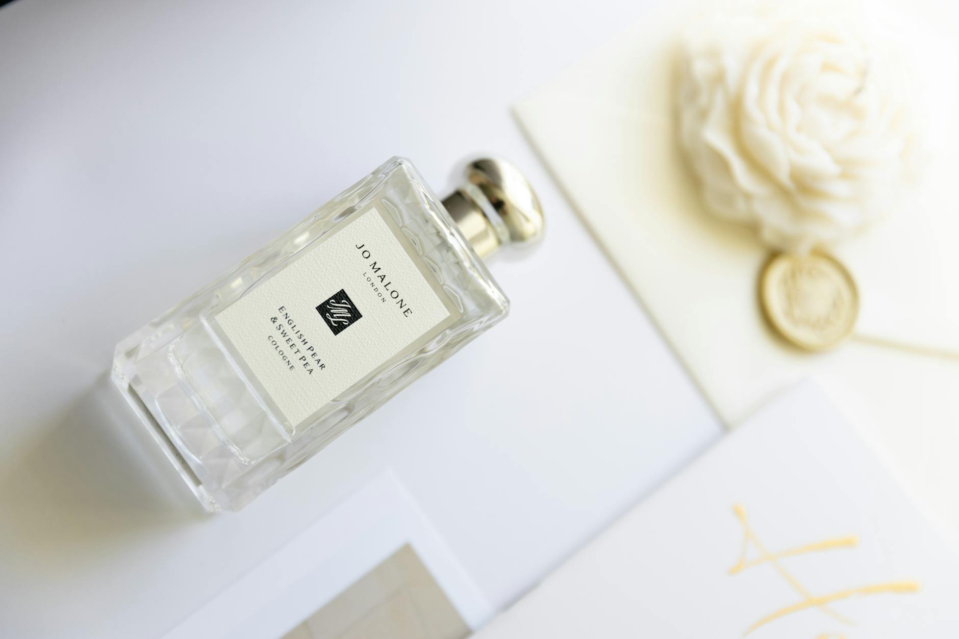 Luxurious scent bottle with floral and gold accents, perfect for lifestyle themes.
