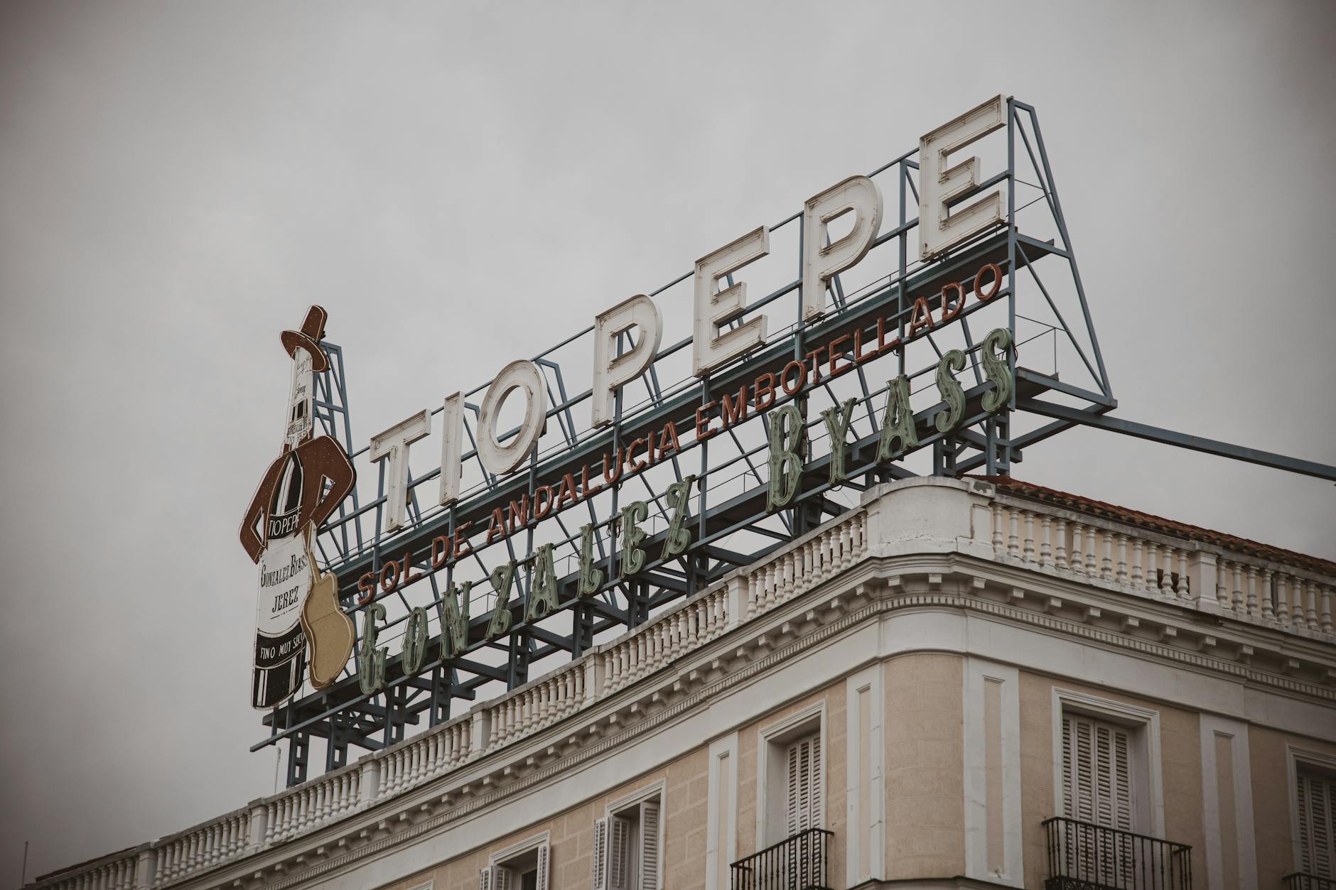 Famous Tio Pepe sign atop a building in Madrid's Puerta del Sol, an iconic city landmark.