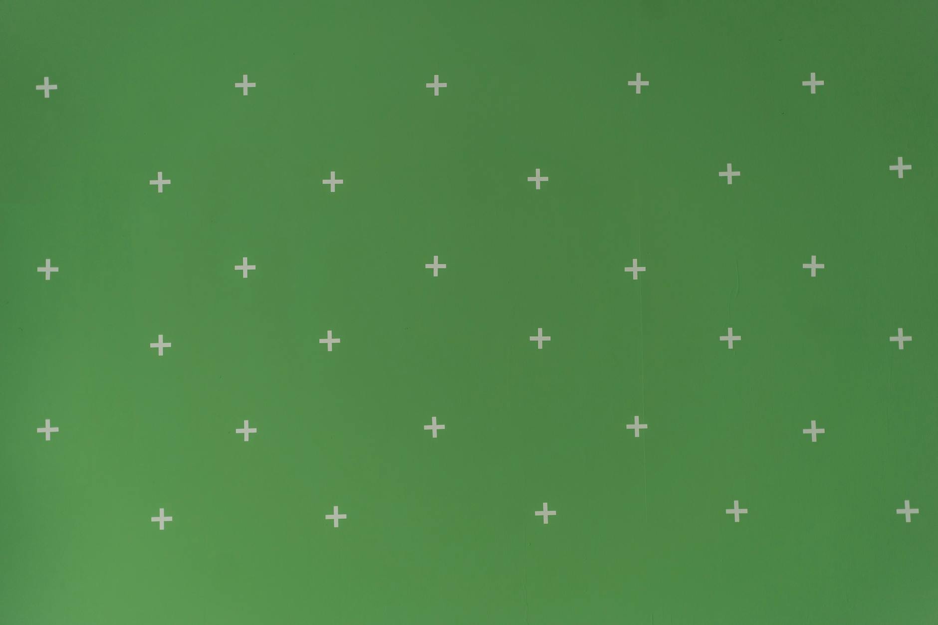 Green screen with white cross markers used for visual effects and post-production.