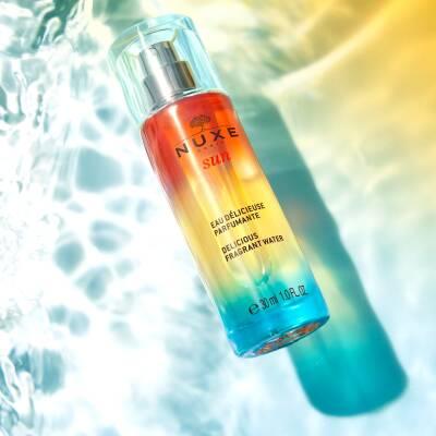 Nuxe Sun Eau Delicieuse Parfumante Body Spray - Tropical Summer Scent with Coconut & Tiare Flower | 30ml Nuxe Sun Body Spray: Tropical Coconut Summer Beach Scent Nuxe Sun fragrance, body spray, summer scent, tropical fragrance, coconut body mist, natural body spray, eau delicieuse parfumante, tiare flower perfume, sun inspired fragrance, beach scent, Nuxe, body mist, perfume, fragrance, tropical, coconut, tiare flower, natural, summer, beach, sweet orange, petitgrain, vanilla, musk, women's fragrance, light