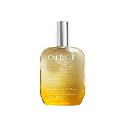 caudalie soleil des vignes elixir oil bottle, application of caudalie elixir oil on skin Caudalie Soleil des Vignes Elixir Oil - Nourishing | 50 ml Caudalie Soleil des Vignes Elixir Oil - Nourishing | 50 ml caudalie, body-oil, vegan, skincare, nourishing-oil, hydrating, summer-scent, non-greasy, natural-beauty, ai-generated