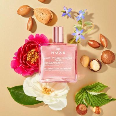 nuxe huile prodigieuse florale 50ml, nuxe multi-purpose shimmering oil packaging, nuxe floral oil application on skin, npm for hair care with nuxe oil Nuxe Huile Prodigieuse Florale - Multi-Purpose Glimmering Oil | 50 ml Nuxe Huile Prodigieuse Florale - Multi-Purpose Oil nuxe, multi-purpose-oil, dry-oil, shimmering-oil, floral-scents, luxury-beauty, skincare, haircare, radiance, ai-generated